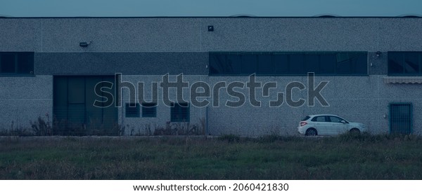 White car parked in front
of a shed