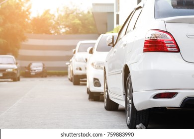 White Car Parked Neatly Inside An Outdoor Parking Lot