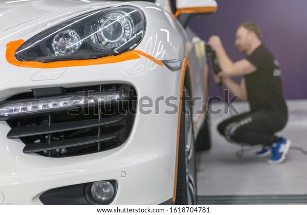 White car in the polishing shop. Car detailing and
polishing concept. 