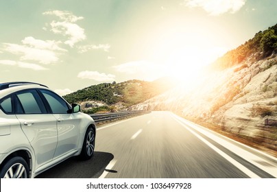 White car rushing along a high-speed highway. Toned photo. - Shutterstock ID 1036497928