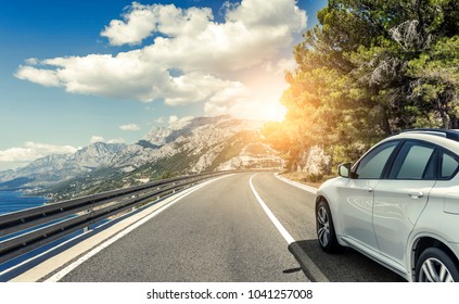 White car rushing along a high-speed highway. Toned photo. - Shutterstock ID 1041257008
