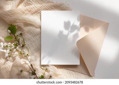 White card mockup with envelope and flowers 