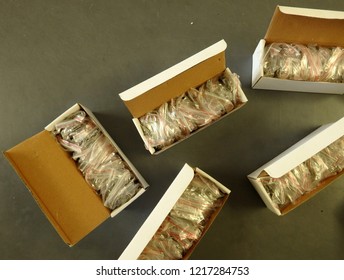 White cardboard boxes full of plastic wraped stuff - Shutterstock ID 1217284753