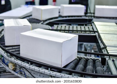 White cardboard boxes on conveyor belt. parcels transportation system concept	