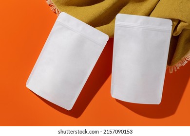 White cardboard packaging for tea, coffee, spices, snack. Branding and packaging mockup on orange background. High quality photo