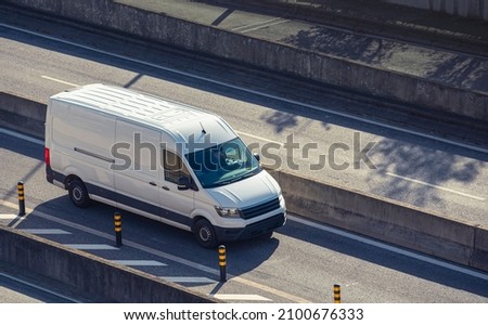 White cargo minivan on the road, delivery van service