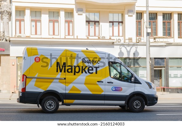 White cargo van branded with the\
brand of a large Russian marketplace Yandex Market. Delivery of\
orders from online stores. Moscow, Russia -\
05.21.2022