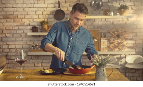 White Casual Man Cooking In Kitchen At Home Serving Food To Plate On Dinner Table