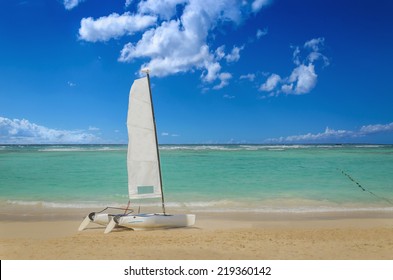 White Catamaran On Exotic Sandy Caribbean Beach