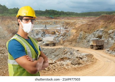 A White Caucasian Coal Miner In A Reflective Bib And Hard Hat Wears A Mask To Prevent COVID-19 After A Day At The Coal Mine.