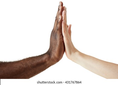 White Caucasian female and black African American male holding hands together in world unity, racial love and understanding concept. Close up shot of two people of different cultures giving five.