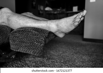 White Caucasian Male With Feet Elevated On Reclining Chair