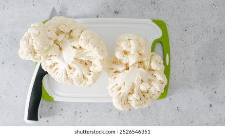 White cauliflower close-up on cutting board on grey background, view from above, copy space - Powered by Shutterstock