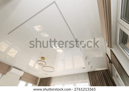 A white ceiling with a built-in thin light strip. Hidden LED lighting creates a 