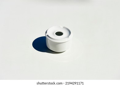 white ceramic ashtray on white table