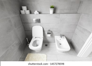 White ceramic bidet and toilet at luxury bathroom, nobody
