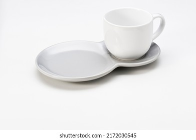White ceramic cup with a double saucer, isolated on white