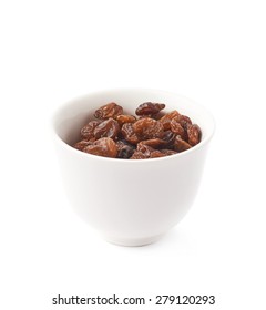 White ceramic cup filled with multiple raisins isolated over the white background