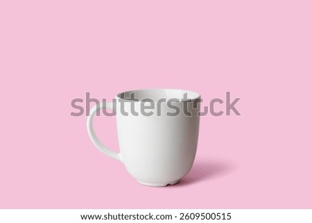 White ceramic empty mug on pink background