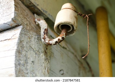 White Ceramic Insulator With Rusty Wire