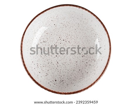 White ceramic plate with dark dots framed by a brown edging on a white background.