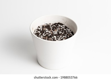 White Ceramic Pot With Porous Soil Mixture In Isolated White Background. 