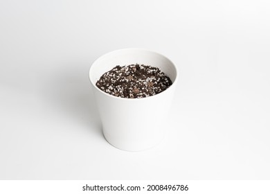 White Ceramic Pot With Porous Soil Mixture In Isolated White Background. 