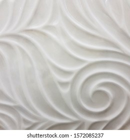 White ceramic tile with abstract pattern for wall and floor decoration. Concrete stone surface background. Glossy porcelain texture for interior design project.
