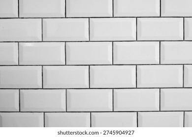 White ceramic tile wall background with clean modern pattern. This simple and orderly texture is perfect for kitchen backsplash or bathroom interior design project