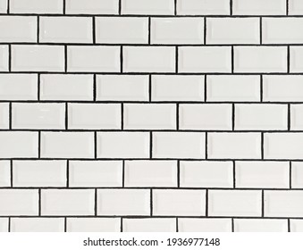 White ceramic tiles with black grout background