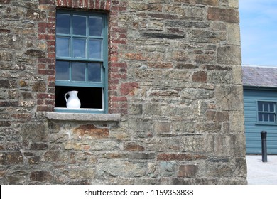 White Ceramic Water Pitcher In Window