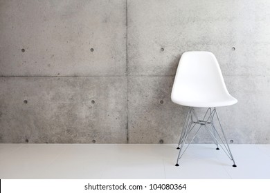 white chair and concrete wall