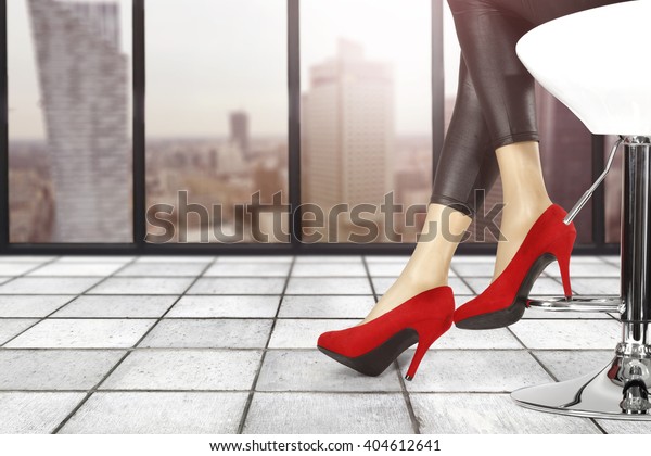 white chair and woman legs and red heels and window\
space 