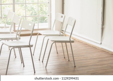 The White Chairs In Meeting Room And Soft Sunlight Through The Window From Outside