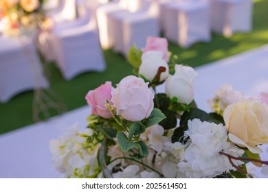 White Chairs With Pink Bows For Wedding Exit Registration.