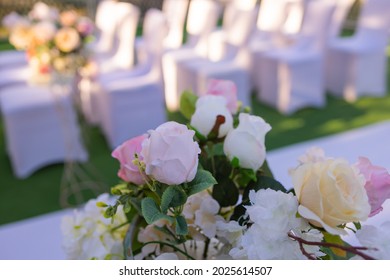 White Chairs With Pink Bows For Wedding Exit Registration.