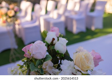 White Chairs With Pink Bows For Wedding Exit Registration.