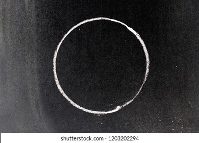 White Chalk Drawing In Circle Shape On Black Board Background