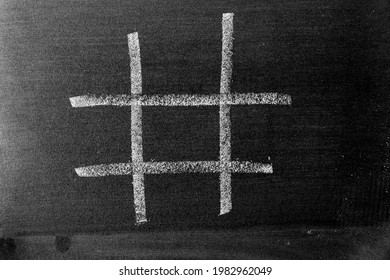 White Chalk Drawing As Hashtag Or Tic Tac Toe Blank Shape On Black Board Background