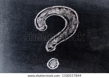 White chalk drawing in questionmark shape on black board background