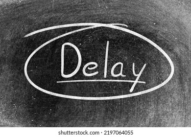 White Chalk Hand Writing In Word Delay On Blackboard Background