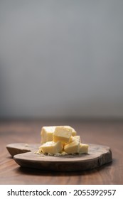 White Cheddar Cheese Pieces On Olive Wood Board