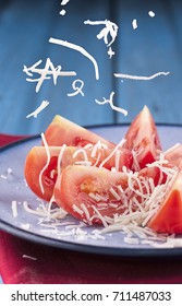 White Cheese Falling On Tomato Slices.