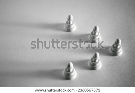 white chess pawns, 5 pawns arranged in a triangle shape
