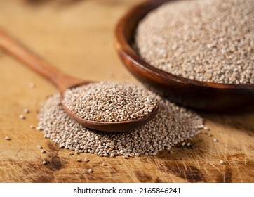 White chia seeds and wooden spoon in a wooden dish placed on a wooden background. Close-up.  - Shutterstock ID 2165846241
