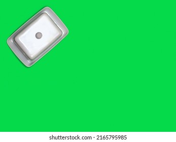 White China Butter Dish On Bright Green Background With Copy Space.  Flat Lay