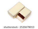 White chocolate candies with filling on a white background. A whole candy and half a candy.