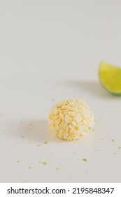 White Chocolate Candies And Lemon Slices On White Background. Food Styling. Spring And Summer Comfort Food.