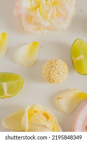 White Chocolate Candies And Lemon Slices On White Background. Food Styling. Spring And Summer Comfort Food.