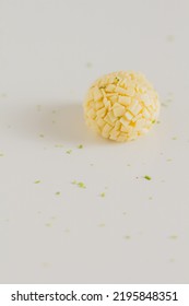 White Chocolate Candies And Lemon Slices On White Background. Food Styling. Spring And Summer Comfort Food.